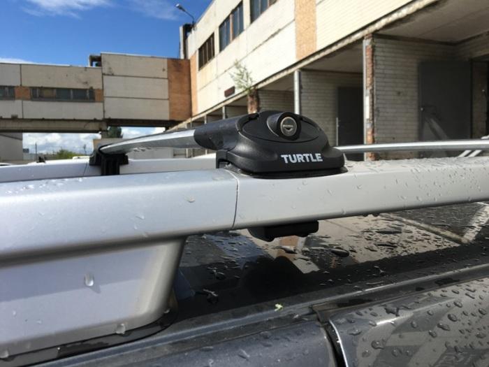 Багажник на крышу Nissan Terrano (2014-...), Turtle Air 1, аэродинамические дуги на рейлинги (серебристый цвет)